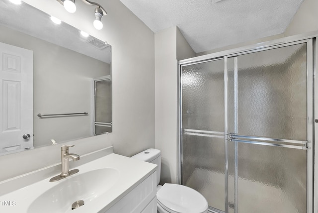 5529 Wood Pond Ct, Raleigh, NC 27610 - bathroom with toilet, vanity, a shower stall, and a textured ceiling