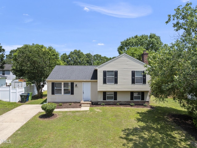 5529 Wood Pond Ct, Raleigh, NC 27610 - tri-level home with a chimney, a shingled roof, and driveway