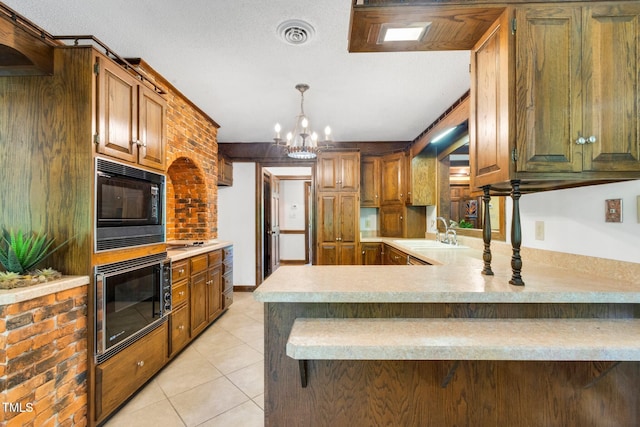 1164 Keith Hills Rd, Lillington, NC 27546 - kitchen with a sink, stainless steel microwave, black microwave, light countertops, and a chandelier