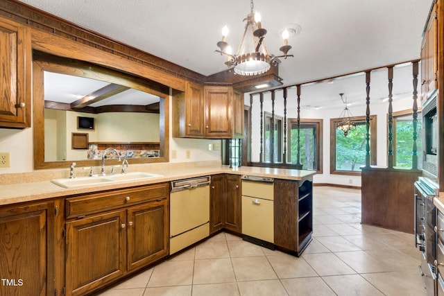 1164 Keith Hills Rd, Lillington, NC 27546 - kitchen with stainless steel dishwasher, a sink, a peninsula, light countertops, and a chandelier