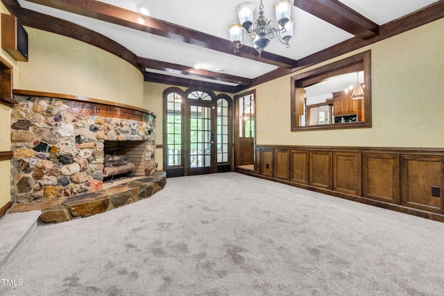 1164 Keith Hills Rd, Lillington, NC 27546 - unfurnished living room featuring carpet, beam ceiling, a chandelier, a stone fireplace, and wainscoting