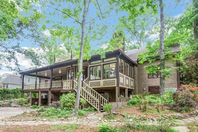 1164 Keith Hills Rd, Lillington, NC 27546 - view of front of property featuring stairway, ceiling fan, a sunroom, brick siding, and a chimney