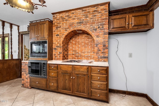 1164 Keith Hills Rd, Lillington, NC 27546 - kitchen with light tile patterned flooring, oven, black microwave, light countertops, and gas cooktop