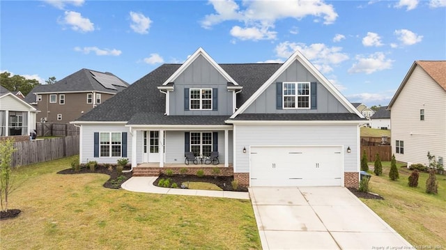 522 Coxwold Pl, Fayetteville, NC 28311 - view of front facade with a porch, board and batten siding, concrete driveway, and a garage