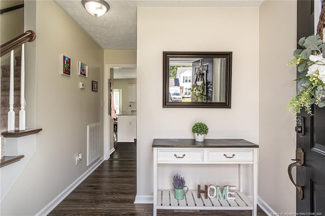 3538 Gables Dr, Fayetteville, NC 28311 - corridor featuring dark wood finished floors, baseboards, and a textured ceiling