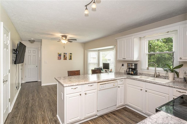 3538 Gables Dr, Fayetteville, NC 28311 - kitchen with white dishwasher, a sink, a peninsula, a ceiling fan, and white cabinets
