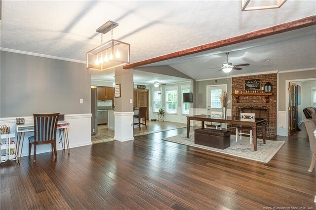 5621 Monks Walk Ct, Fayetteville, NC 28311 - dining room featuring a fireplace, dark wood-style flooring, a ceiling fan, wainscoting, and ornamental molding