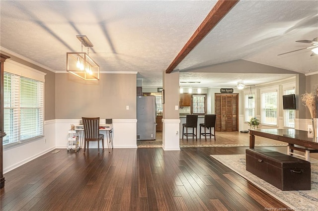 5621 Monks Walk Ct, Fayetteville, NC 28311 - living room with a textured ceiling, dark wood-style flooring, ceiling fan, a wainscoted wall, and crown molding