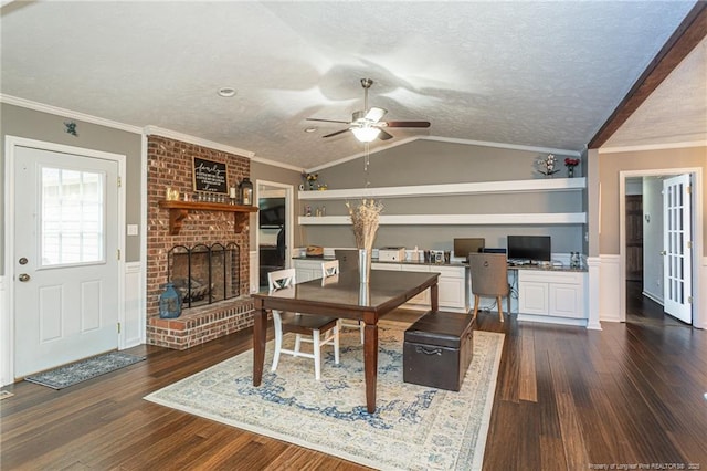 5621 Monks Walk Ct, Fayetteville, NC 28311 - dining room featuring ceiling fan, a brick fireplace, dark wood-type flooring, a textured ceiling, and lofted ceiling