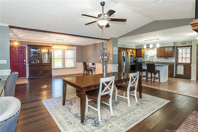 5621 Monks Walk Ct, Fayetteville, NC 28311 - dining room featuring ceiling fan, dark wood-type flooring, a textured ceiling, crown molding, and baseboards