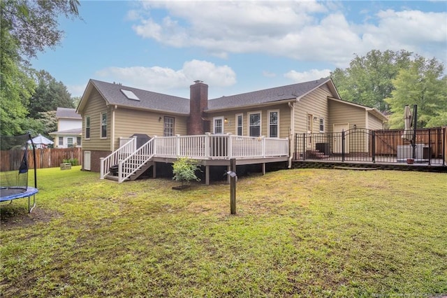 5621 Monks Walk Ct, Fayetteville, NC 28311 - rear view of house featuring a trampoline, a deck, a chimney, and stairway