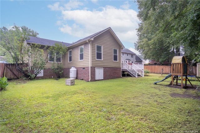 5621 Monks Walk Ct, Fayetteville, NC 28311 - rear view of house featuring a playground and stairs