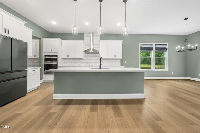 20 Scotland Dr, Youngsville, NC 27596 - kitchen featuring freestanding refrigerator, wall chimney exhaust hood, light countertops, backsplash, and double oven