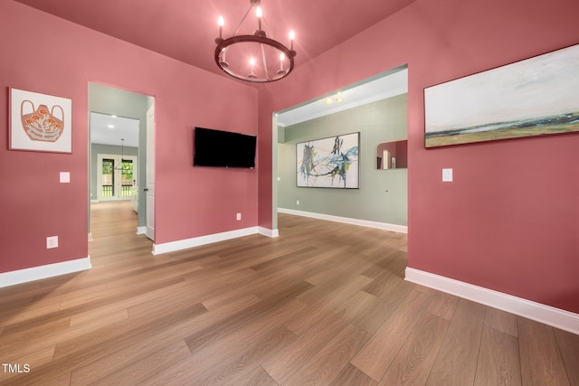 20 Scotland Dr, Youngsville, NC 27596 - empty room with a chandelier, wood finished floors, and baseboards