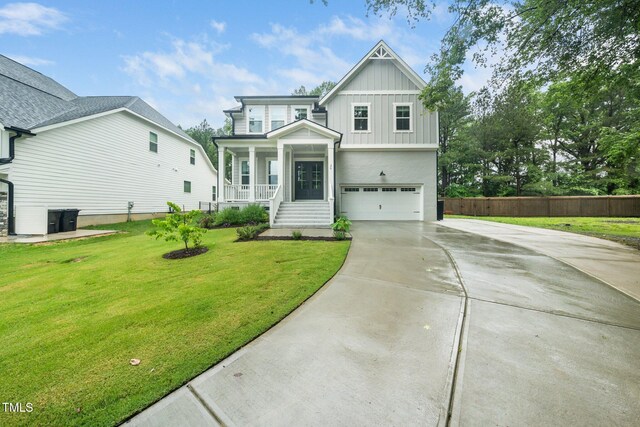 20 Scotland Dr, Youngsville, NC 27596 - view of front facade featuring board and batten siding, concrete driveway, a garage, and covered porch