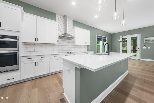 20 Scotland Dr, Youngsville, NC 27596 - kitchen with wall chimney range hood, double oven, a sink, light wood-style floors, and decorative backsplash