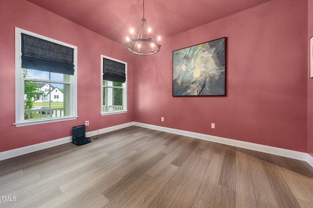 20 Scotland Dr, Youngsville, NC 27596 - spare room featuring wood finished floors, a chandelier, and baseboards