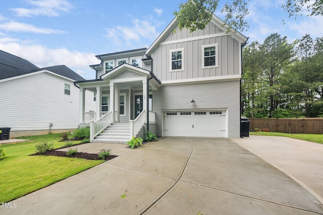 20 Scotland Dr, Youngsville, NC 27596 - view of front facade featuring board and batten siding, an attached garage, brick siding, a porch, and driveway