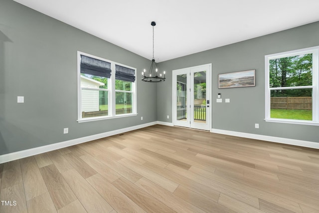 20 Scotland Dr, Youngsville, NC 27596 - unfurnished dining area with a chandelier, light wood-type flooring, plenty of natural light, and baseboards