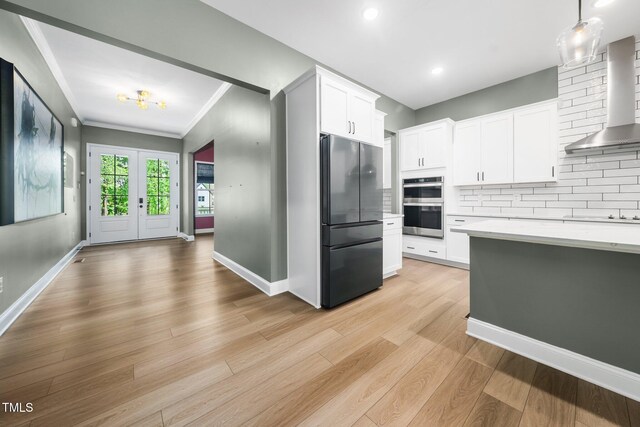 20 Scotland Dr, Youngsville, NC 27596 - kitchen featuring stainless steel appliances, wall chimney exhaust hood, light countertops, decorative backsplash, and white cabinets