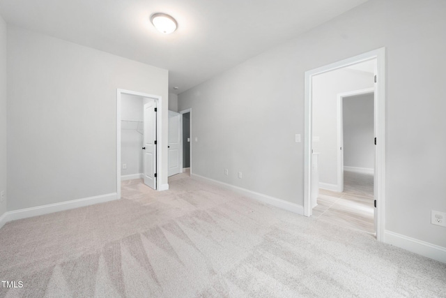 20 Scotland Dr, Youngsville, NC 27596 - unfurnished bedroom with carpet, a walk in closet, and baseboards