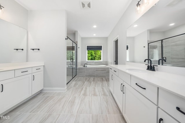 20 Scotland Dr, Youngsville, NC 27596 - full bathroom featuring vanity, a shower stall, a garden tub, recessed lighting, and baseboards