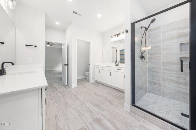 20 Scotland Dr, Youngsville, NC 27596 - bathroom featuring a stall shower, vanity, toilet, ceiling fan, and recessed lighting