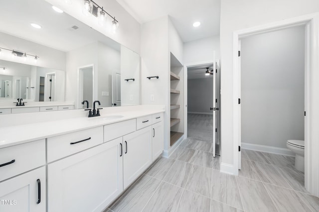 20 Scotland Dr, Youngsville, NC 27596 - bathroom featuring vanity, toilet, baseboards, a ceiling fan, and recessed lighting
