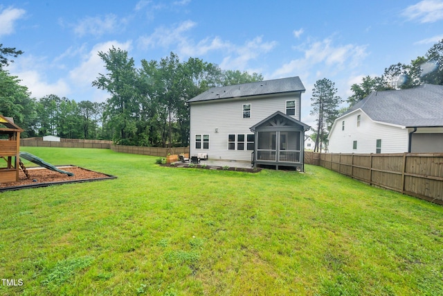 20 Scotland Dr, Youngsville, NC 27596 - rear view of house featuring a sunroom, a patio, and a playground