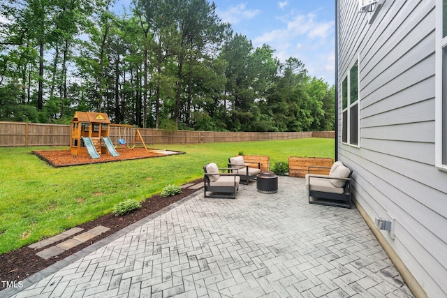 20 Scotland Dr, Youngsville, NC 27596 - view of patio / terrace with an outdoor living space, a playground, and view of wooded area
