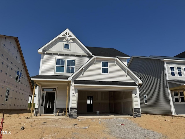 264 Meadowbark Bnd Unit 43, Garner, NC 27529 - craftsman-style home featuring board and batten siding, stone siding, gravel driveway, and a garage