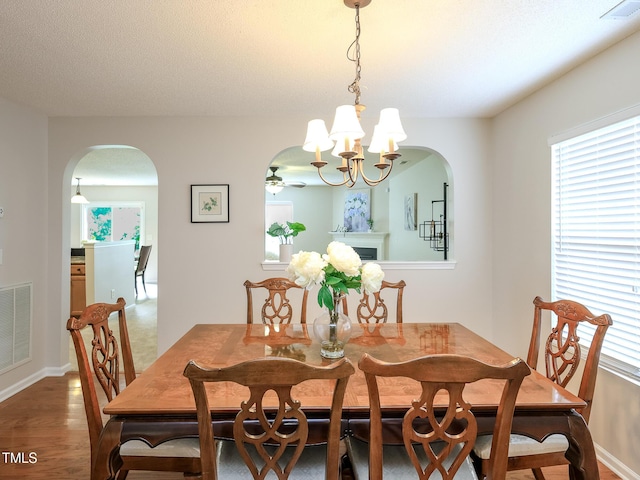 3515 Mountain Brook Cir, Durham, NC 27704 - dining room with arched walkways, plenty of natural light, a chandelier, and wood finished floors
