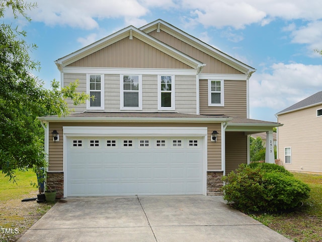 3515 Mountain Brook Cir, Durham, NC 27704 - view of front of house with stone siding, an attached garage, and concrete driveway