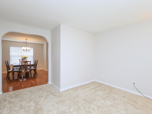 3515 Mountain Brook Cir, Durham, NC 27704 - dining space featuring arched walkways, carpet, a chandelier, and baseboards