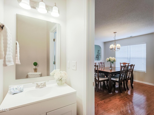 3515 Mountain Brook Cir, Durham, NC 27704 - bathroom with vanity, wood-type flooring, a chandelier, and toilet