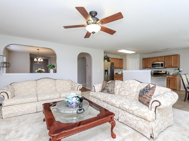 3515 Mountain Brook Cir, Durham, NC 27704 - living area with arched walkways, a chandelier, a ceiling fan, and light colored carpet