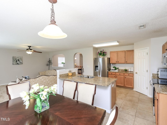 3515 Mountain Brook Cir, Durham, NC 27704 - dining space with arched walkways, ceiling fan, light tile patterned floors, and a textured ceiling
