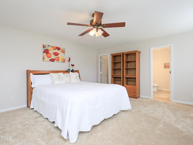 3515 Mountain Brook Cir, Durham, NC 27704 - bedroom with light colored carpet, baseboards, connected bathroom, and ceiling fan