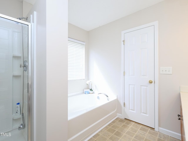 3515 Mountain Brook Cir, Durham, NC 27704 - bathroom with a stall shower, a garden tub, baseboards, and vanity