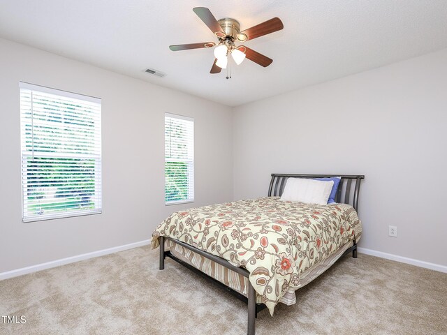 3515 Mountain Brook Cir, Durham, NC 27704 - bedroom with light carpet, baseboards, and a ceiling fan