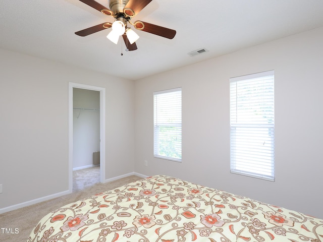 3515 Mountain Brook Cir, Durham, NC 27704 - bedroom with light colored carpet, a spacious closet, baseboards, a closet, and ceiling fan