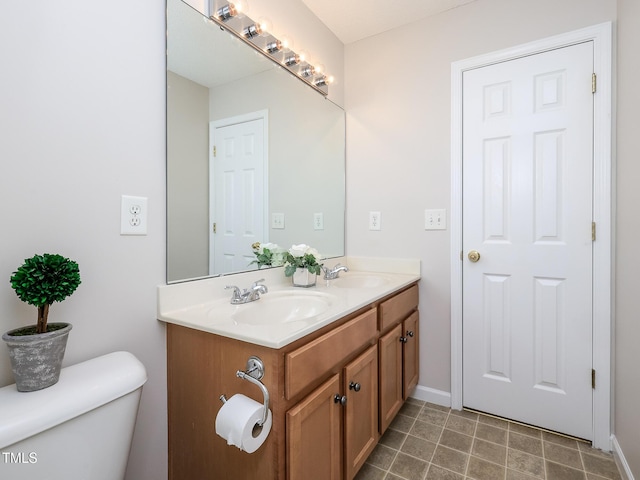 3515 Mountain Brook Cir, Durham, NC 27704 - bathroom with double vanity, toilet, and baseboards