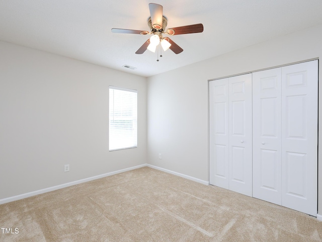 3515 Mountain Brook Cir, Durham, NC 27704 - unfurnished bedroom featuring carpet flooring, a closet, baseboards, and ceiling fan