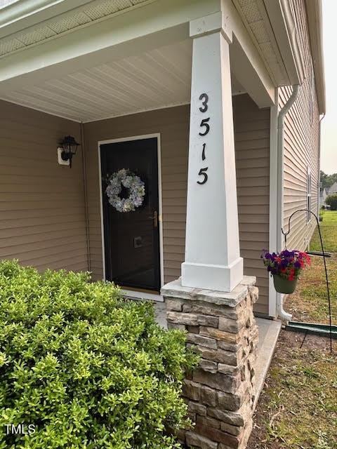3515 Mountain Brook Cir, Durham, NC 27704 - view of exterior entry featuring a porch