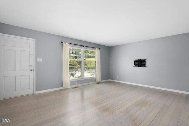 4021 Chaucer Dr, Durham, NC 27705 - unfurnished living room with wood finished floors and baseboards