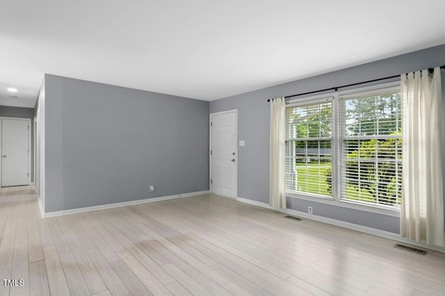 4021 Chaucer Dr, Durham, NC 27705 - unfurnished living room featuring baseboards and light wood finished floors