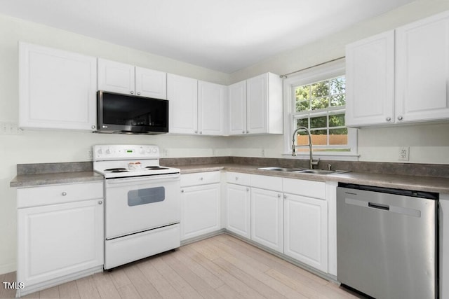 4021 Chaucer Dr, Durham, NC 27705 - kitchen with dishwasher, white range with electric stovetop, black microwave, a sink, and white cabinetry