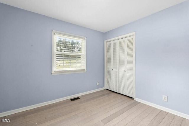 4021 Chaucer Dr, Durham, NC 27705 - unfurnished bedroom with wood finished floors, baseboards, and a closet
