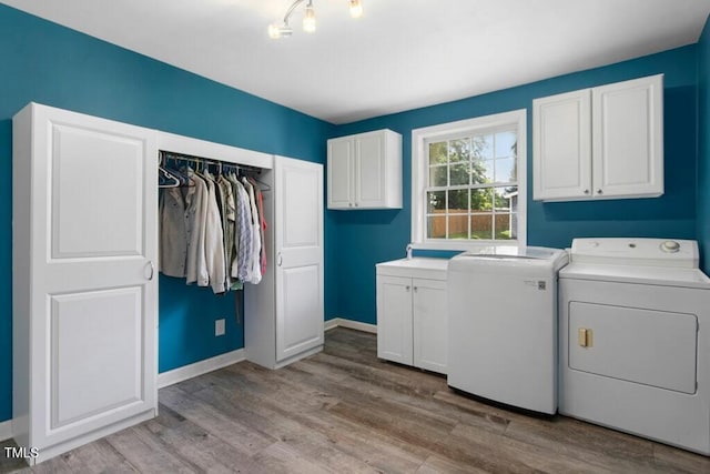 4021 Chaucer Dr, Durham, NC 27705 - laundry area with cabinet space, separate washer and dryer, wood finished floors, and baseboards