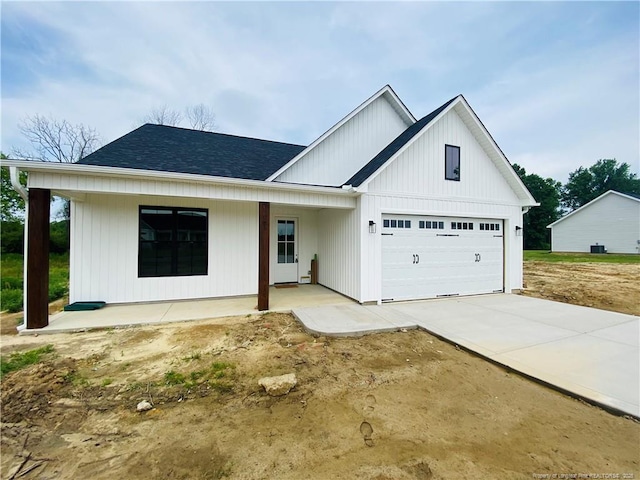 285 Delmore Rd, Autryville, NC 28318 - modern inspired farmhouse with an attached garage, driveway, a shingled roof, and covered porch